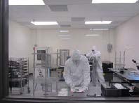 Laboratory technicians performing coating services in clean room Clean Room